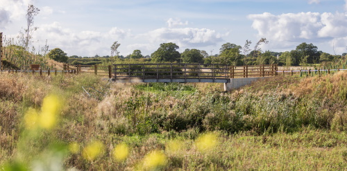 This image: a photo of a large landscaped open space at Peddimore.
							The map: The map shows the Thrive site boundary, with interactive map markers, bringing up 
							illustrative images when clicked on.